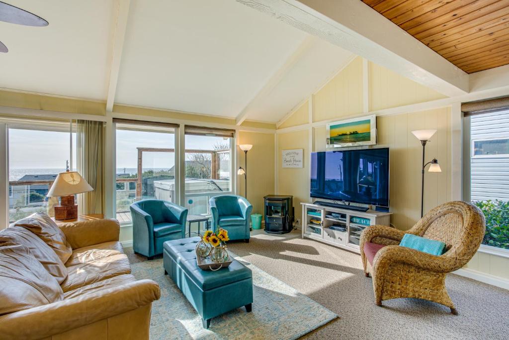 a living room with a couch and chairs and a tv at Ocean Views and Short Walk to Sandy Beach! Changes in Attitude in Bayshore