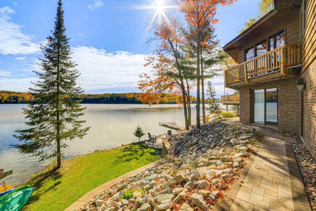 a house with a view of a lake at All-Season Adventures! Chicaugon Lakefront Gem in Mapleton