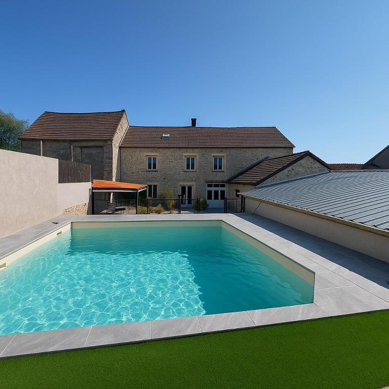 a large swimming pool in front of a house at La Nomalina in Coulonges-en-Tardenois