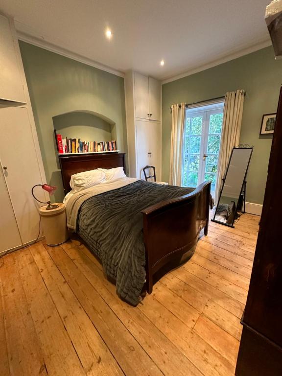 a bedroom with a bed and a book shelf at Central Boutique Townhouse in London