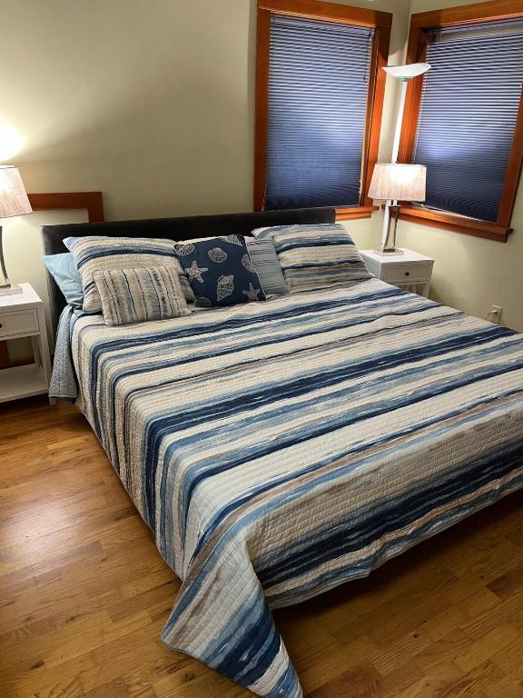 a large bed in a bedroom with two lamps at Art and Book Lovers in Eugene