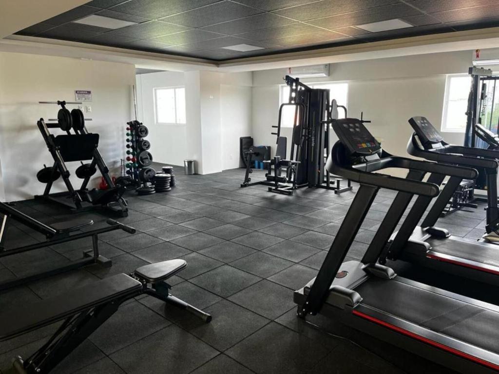 a gym with several tread machines in a room at West fit 720 in Mossoró