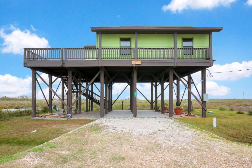 a yellow house with a deck on top of it at Escape Bay Views Large Deck Group Ready in Port Bolivar