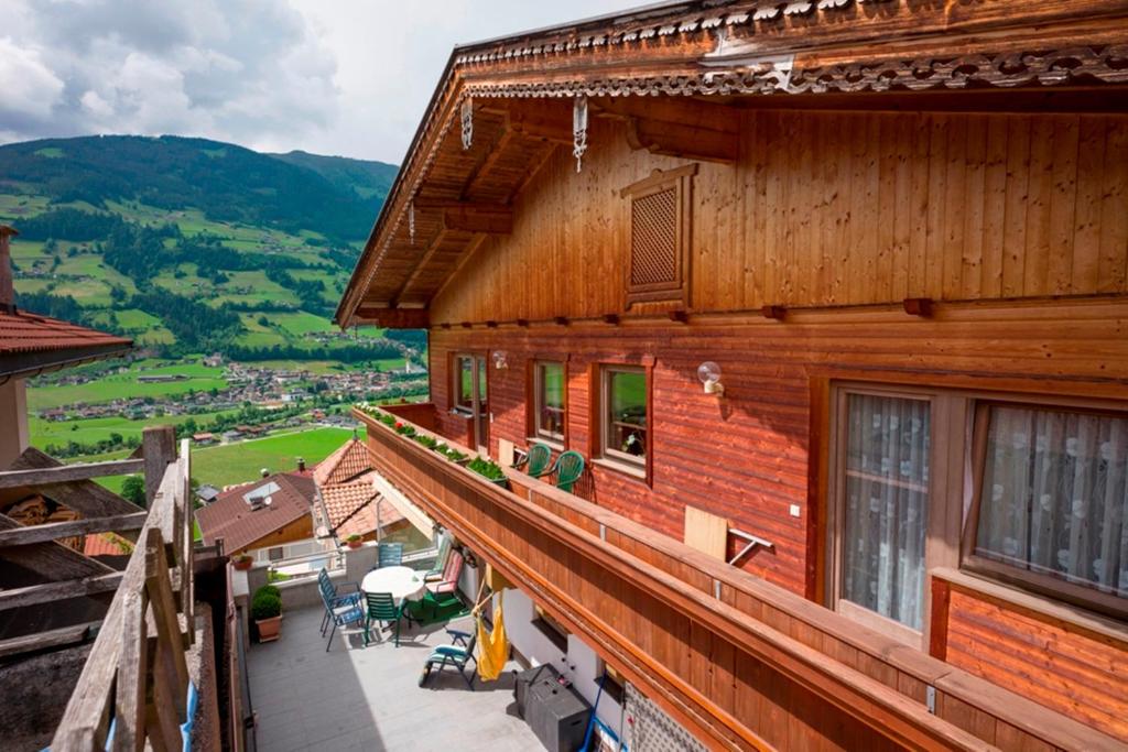 a wooden building with a balcony with a view at Ferienwohnung Eberharter Theresia in Ramsau im Zillertal