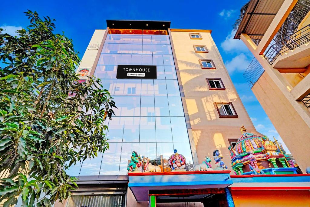 a tall building with a sign on the side of it at Townhouse Bangalore Kundalahalli Metro Station in Bengaluru