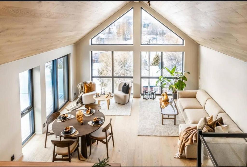 a living room with a couch and a table at New house in the center of Trysil 2 in Trysil