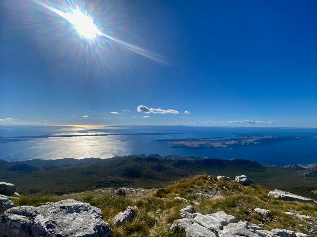 a view of the ocean from the top of a mountain at Stinica apartma Paradise in Stinica