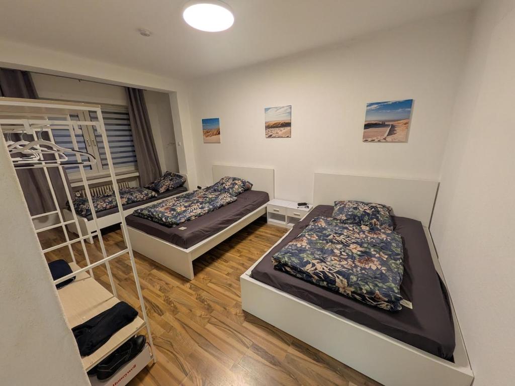 a room with two beds and a staircase at Voll eingerichtete Wohnung in Geilenkirchen in Geilenkirchen