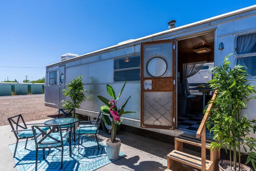 an old airstream trailer with a table and chairs at Spartan Royal Mansion in Tombstone