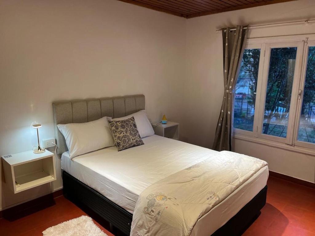 a bedroom with a bed and a window at Casa bulgara boutique in Aristóbulo del Valle