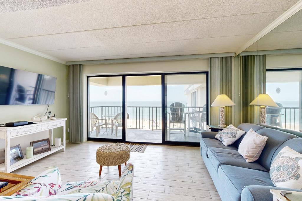 a living room with a couch and a television at Waikiki 406 in Ocean City