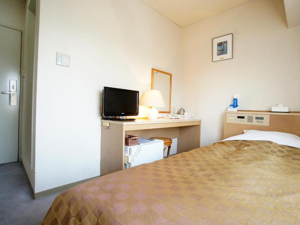 Postel nebo postele na pokoji v ubytování Hotel Trend Nagano