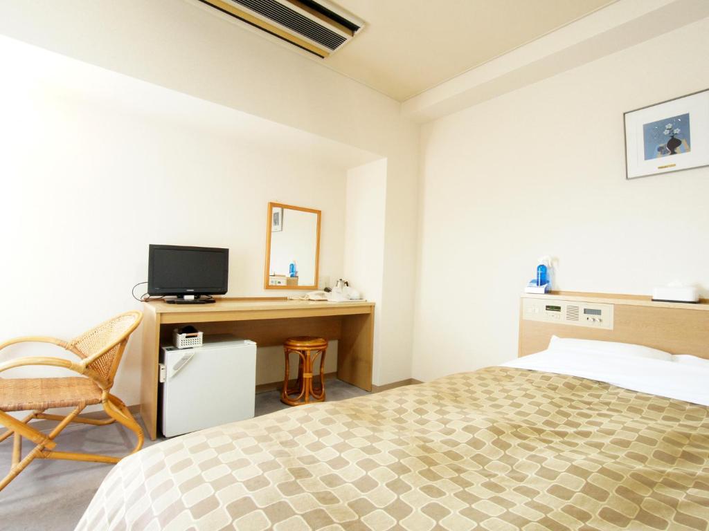 Postel nebo postele na pokoji v ubytování Hotel Trend Nagano