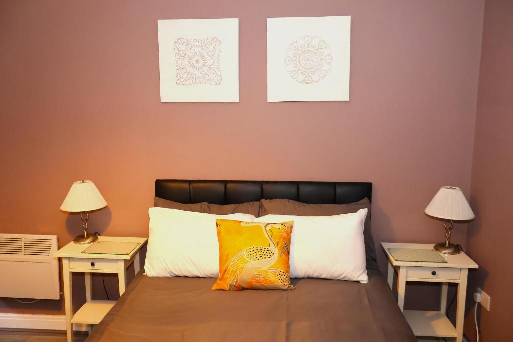 a bedroom with a bed with two two night stands at The Savile - Luxury Apartment Leeds - Your Next Stay in Leeds