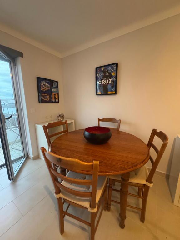 a dining room table with chairs and a bowl on it at Sunset Paradise in Caminha