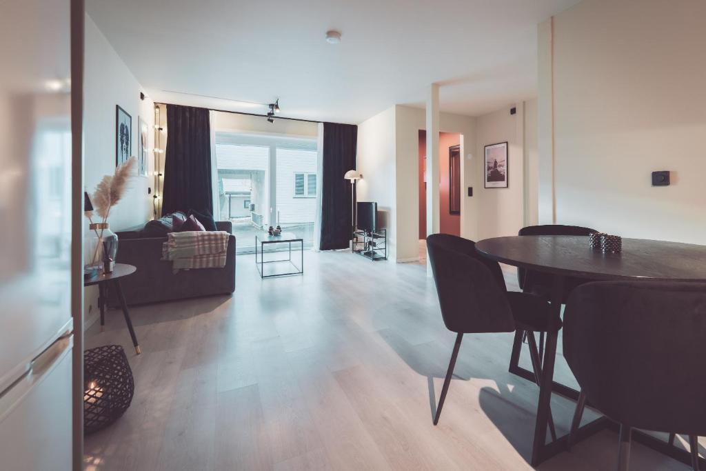 a living room with a table and a couch at Modern Flat In Tromsø Centre in Tromsø