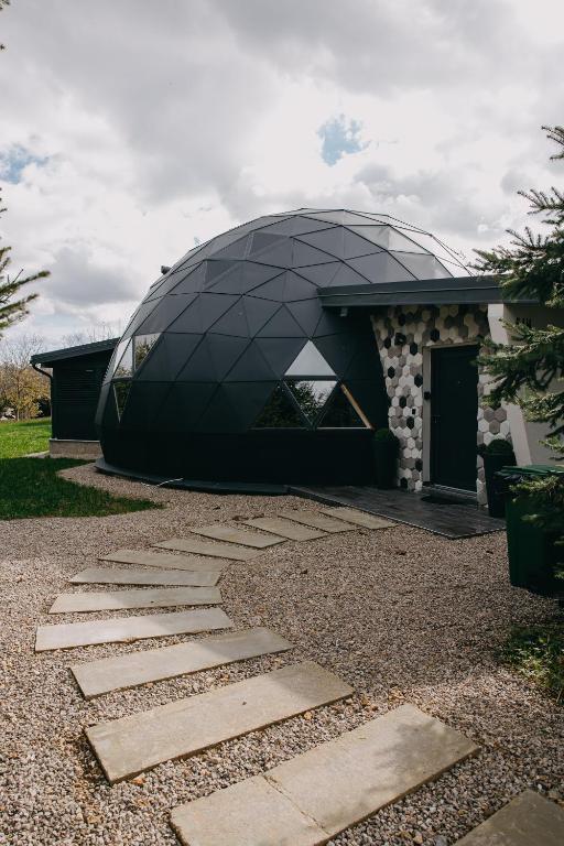 a building with a glass dome on top of it at Dome Noire in Puškarič Selo