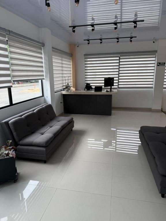 a living room with a couch and a table at Fratello Hotel in Buga