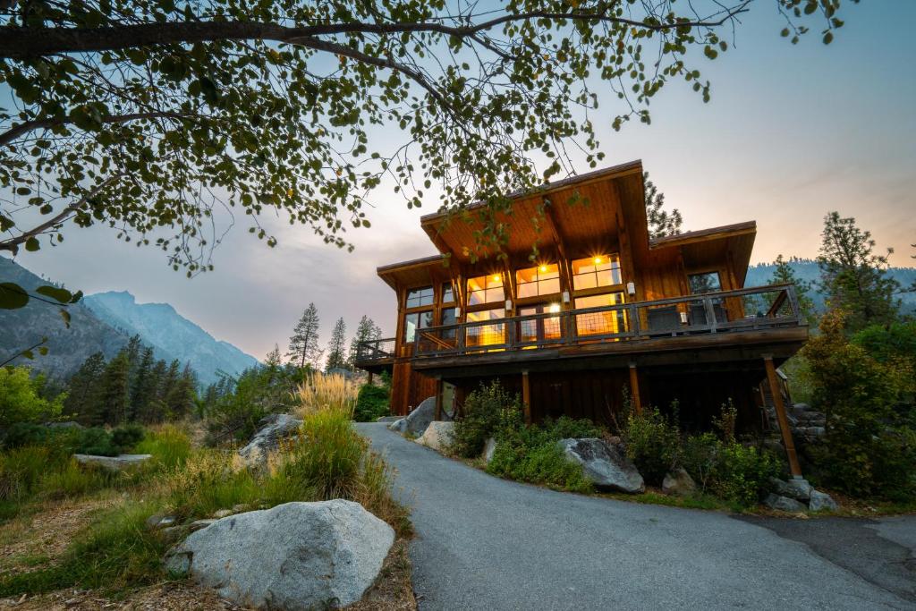 a house in the mountains with a road leading up to it at Sleeping Lady Mountain Resort & Spa in Leavenworth