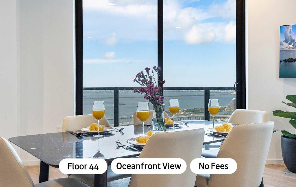 a dining room with a table with a view of the ocean at MVR Luxury King Suite Overlooking Biscayne Bay in Miami