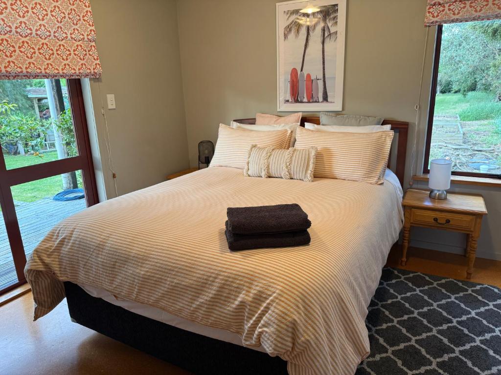 a bedroom with a bed with a towel on it at Country Cutie-Pie, close to town in Hastings