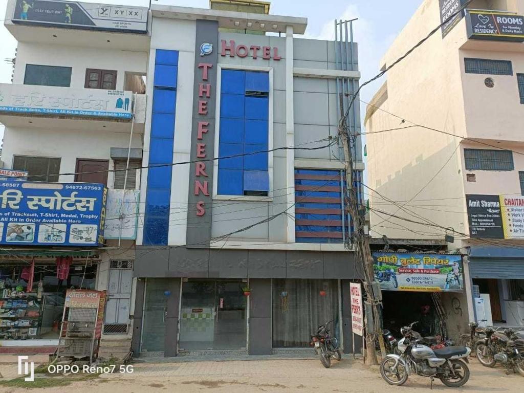 a building with a motorcycle parked in front of it at Hotel O The Ferns in Thānesar