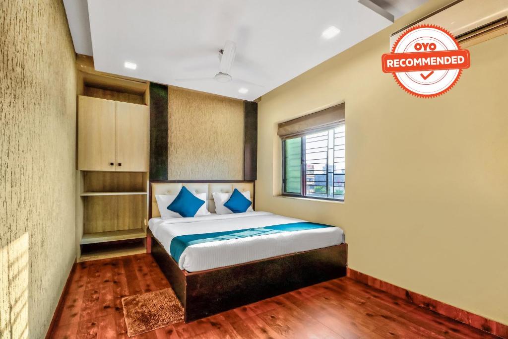 a bedroom with a bed and a sign that reads reopened at Super Hotel O Park Circus Near Birla Mandir in Kolkata