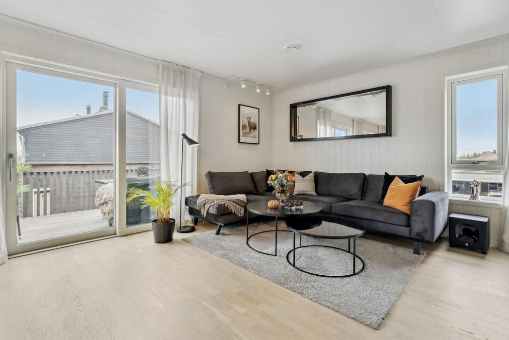a living room with a couch and a table at Modern apartment in Elverum in Elverum
