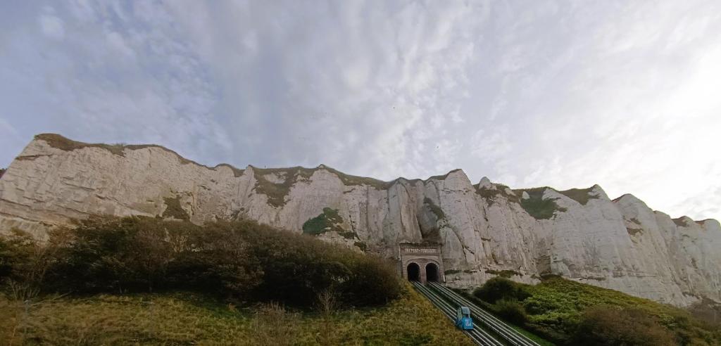 a mountain with a tunnel in front of it at L'échappée Belle face aux Falaises in Le Tréport