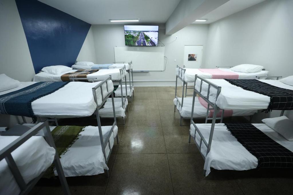 a room with a bunch of beds in it at Hostel Oficial COP30 in Belém