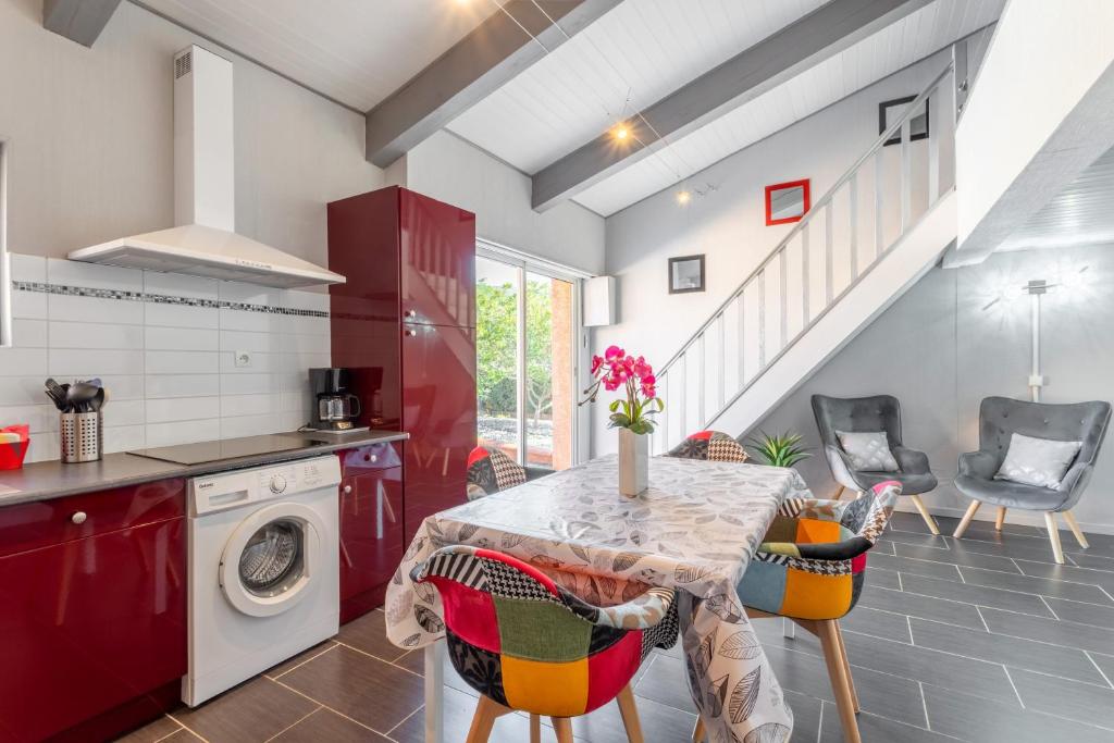a kitchen with a table and a washing machine at Logis Du Conflent in Rodès