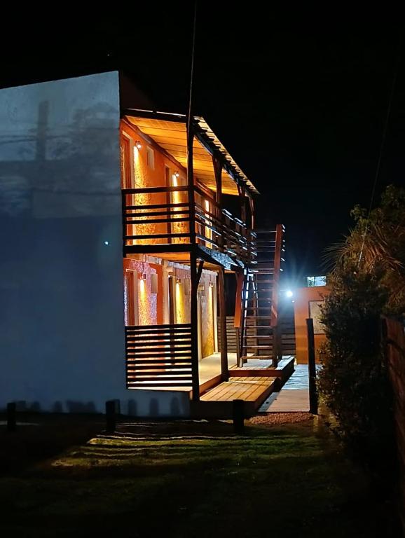 a house with lights on the side of it at night at Aparts Dunas de Valizas in Barra de Valizas