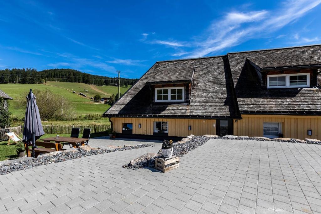 a stone patio in front of a house at Mühlen Chalet in Titisee-Neustadt