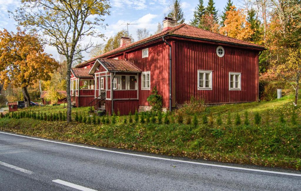a red house sitting on the side of a road at Lovely Home In Kopparberg With Sauna in Kopparberg