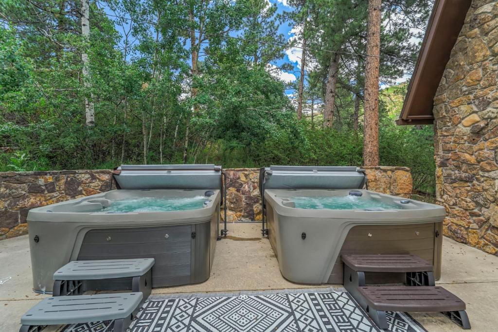 two hot tubs sitting next to a stone wall at 4925 Pike Unit1 in Cascade-Chipita Park