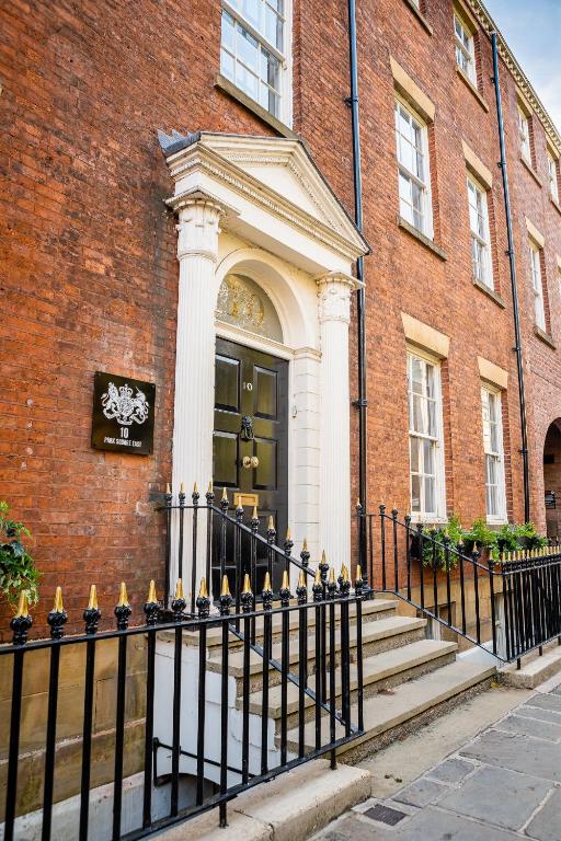 a black fence in front of a building with a door at 10 Park Square East, Luxury Serviced Apartments in Leeds