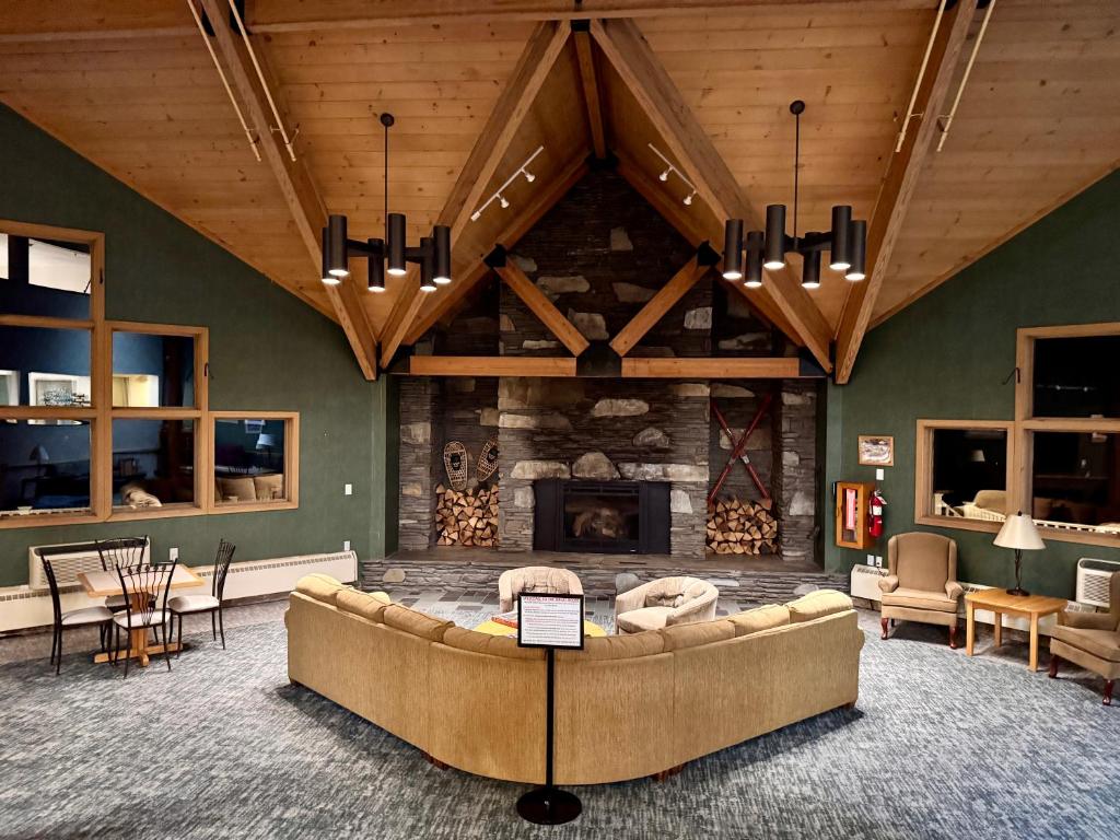 a living room with a couch and a fireplace at Loon Mountain Retreat with Pool and Hot Tub in Lincoln