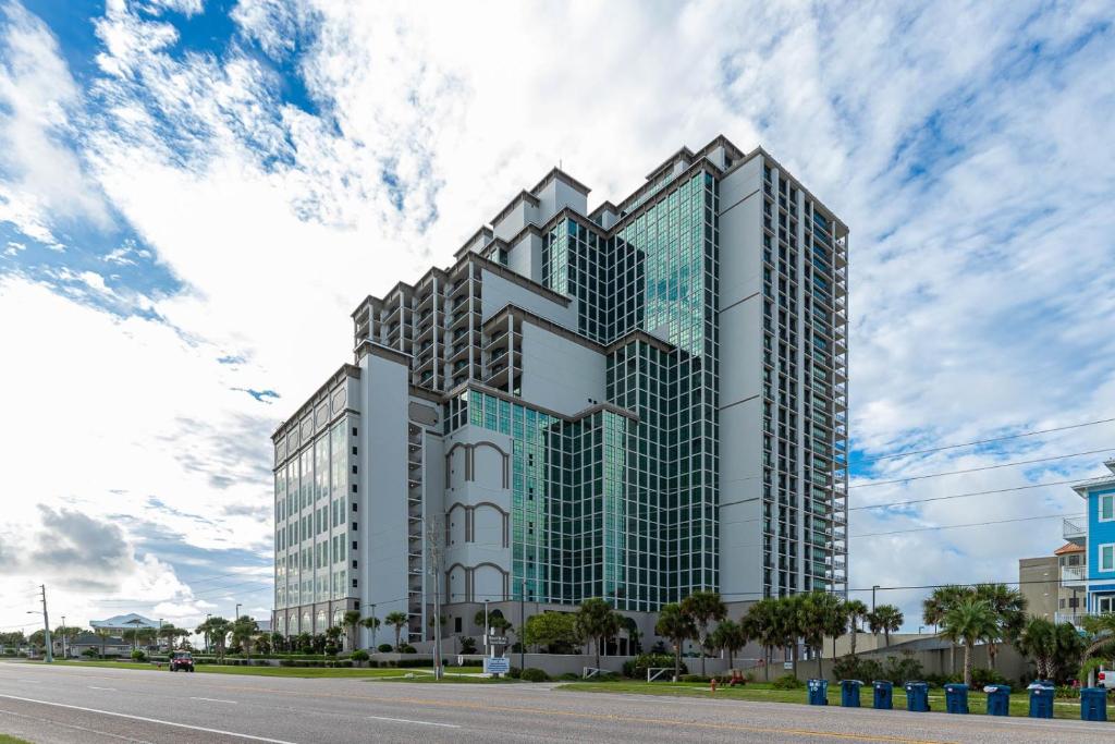 a tall office building with a sky at The Oasis 2209 formerly Phoenix West II 2209 condo in Romar Beach
