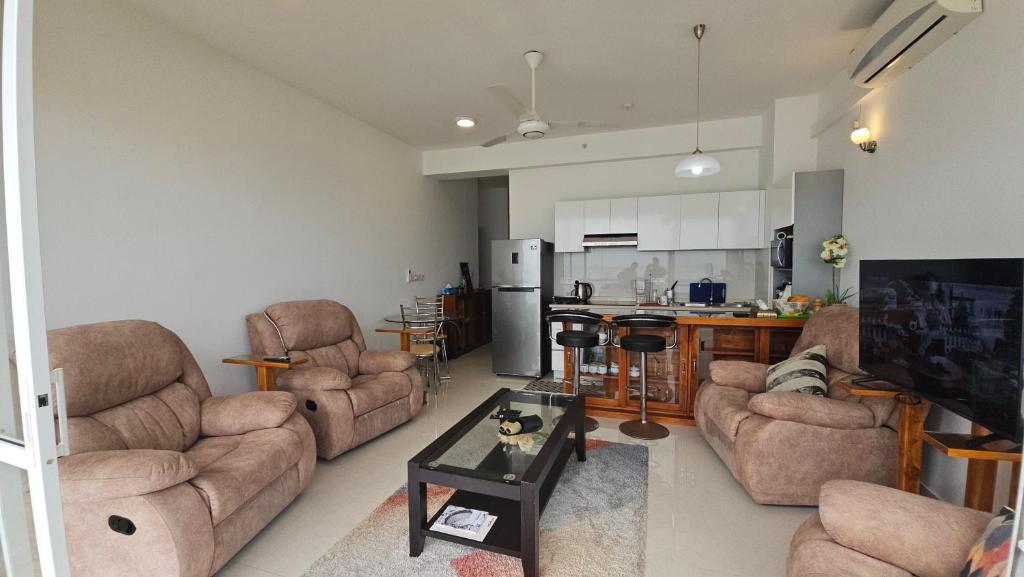 un salon avec des canapés, des chaises et une cuisine dans l'établissement Ocean Paradise Luxury, à Nikawatawana