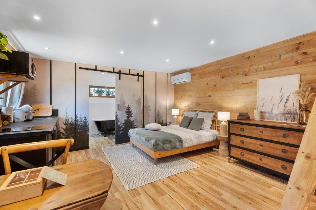 a bedroom with a bed and a wooden wall at Essencia in Toulon