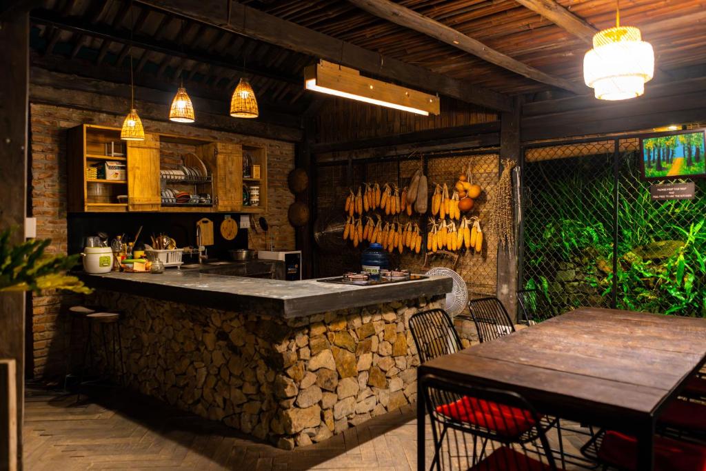 a bar in a restaurant with a table and chairs at De Yang House Sa Pa in Sapa