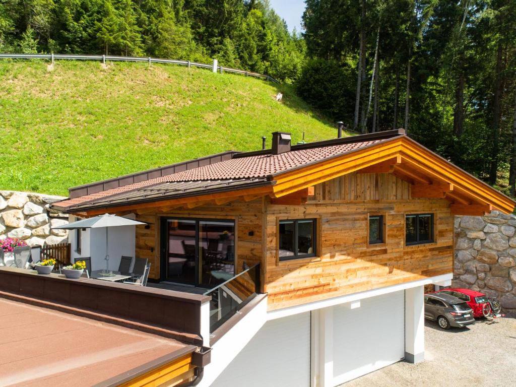a house with a wrap around porch with a roof at Chalet Georg in Zellberg