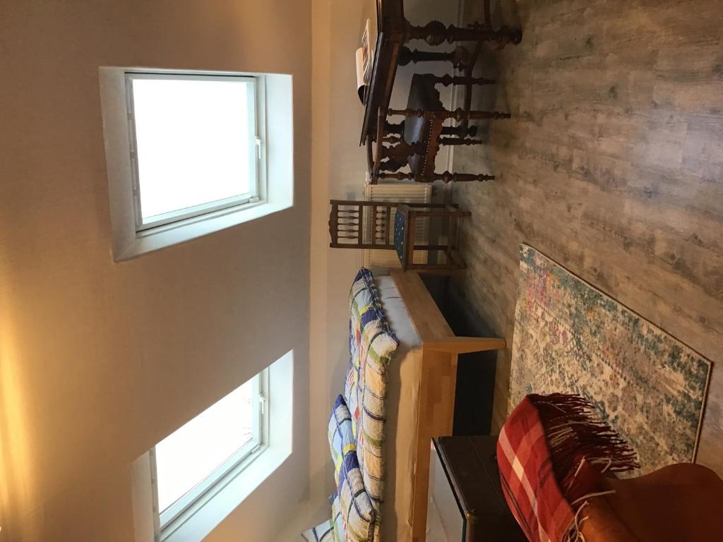 a room with two windows and a couch in it at Zur Henne in Weinbach