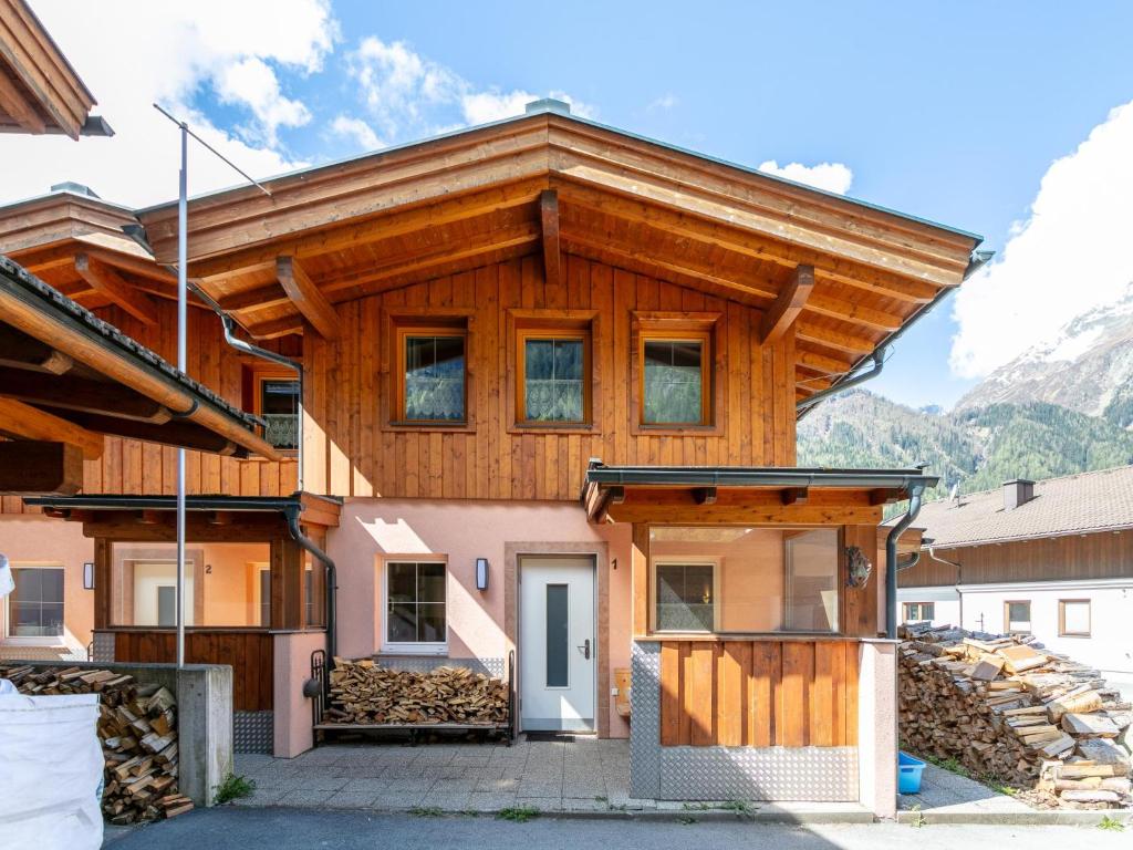 a house in the mountains with a wooden roof at Haus Oliver 1 in Längenfeld