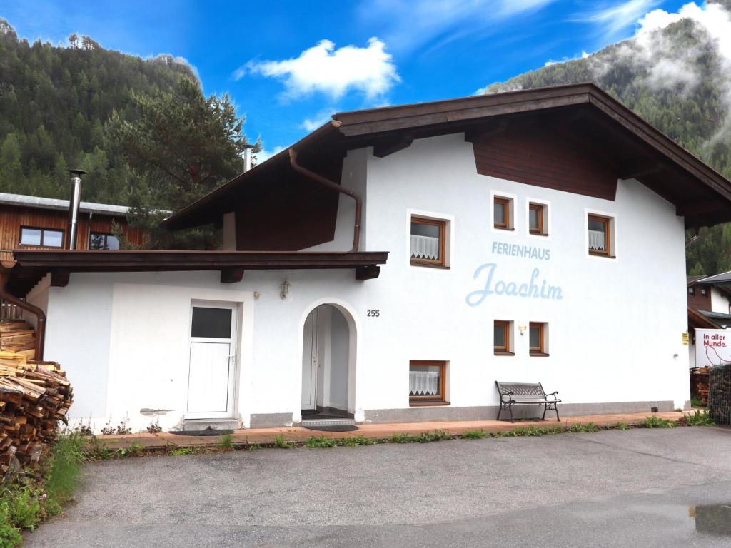 a white building with a sign on it at Haus Joachim in Längenfeld