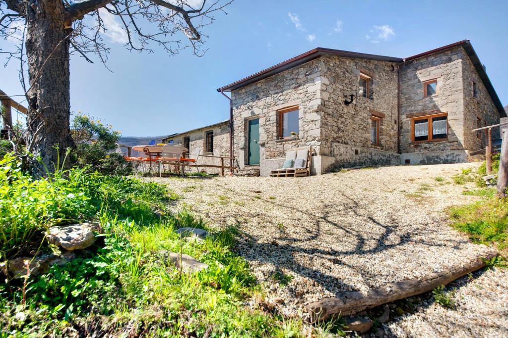 an exterior view of a stone house on a hill at Nature House Custu Giancu in Cichero