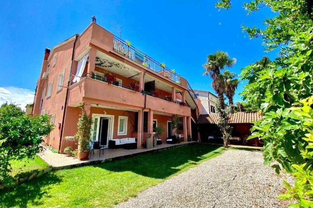 an exterior view of a house with a yard at Apartments by the sea Novigrad - 24877 in Novigrad Istria