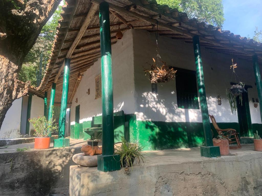 a building with green columns in front of it at Casa Victoria in Piedecuesta