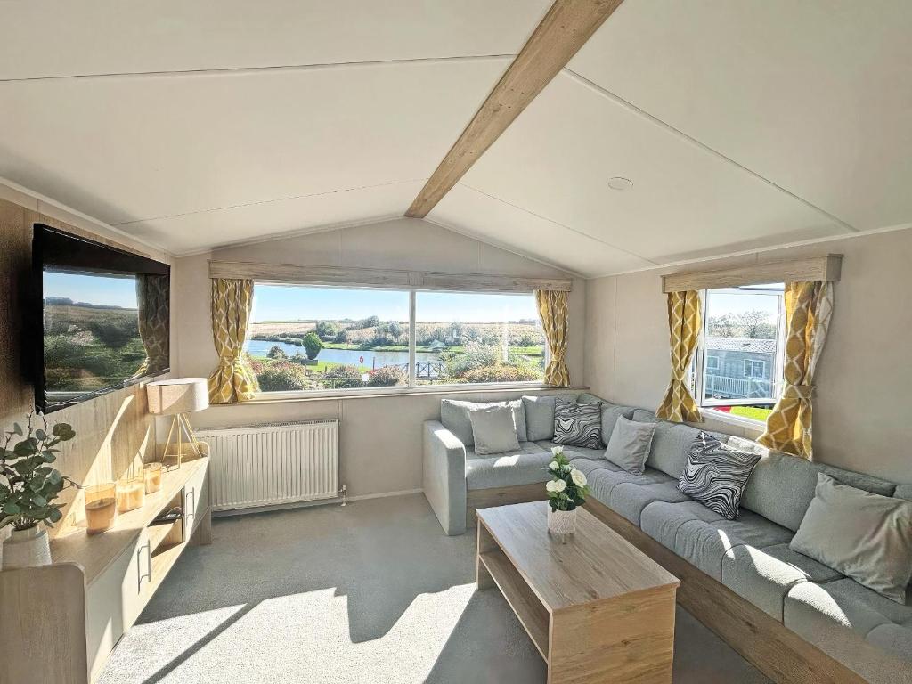 a living room with a couch and a table at Waterside Lodge in Tunstall