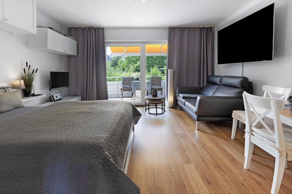 a bedroom with a bed and a living room at Boutique Apartment Anybody in Gaienhofen